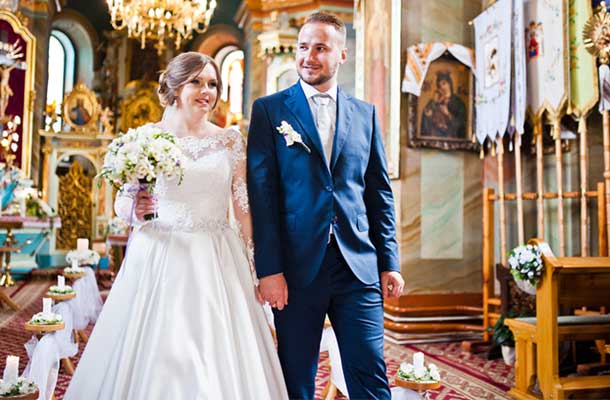 Bride and groom walking down the aisle in church