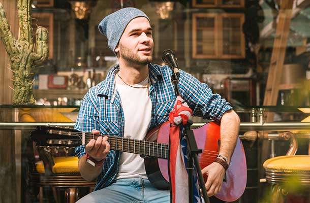 man with hat and guitar